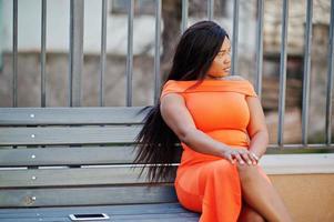 African american woman model xxl in orange dress. photo