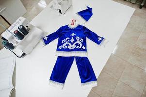 Children's carnival hand made boy costume at seamstress office on workplace. photo