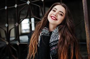 Brunette stylish casual girl in scarf against abandoned factory place. photo