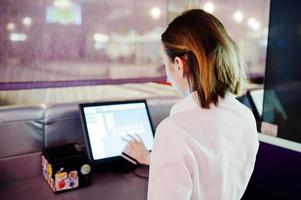 Waiter girl working with pos terminal or cashbox at cafe. People and service concept photo