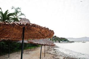 Bamboo and reed straw beach umbrellas photo