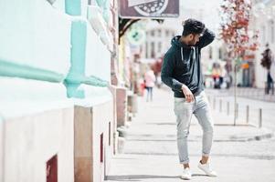 Portrait of young stylish indian man model pose in street. photo