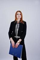 Portrait of a redheaded businesswoman wearing striped blouse and a jacket with a blue folder. photo