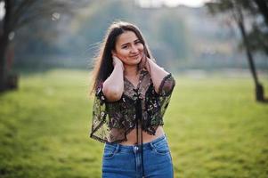 Pretty latino model girl from Ecuador wear on jeans posed at street. photo