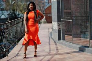 African american woman model xxl in orange dress. photo