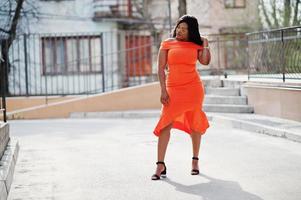 African american woman model xxl in orange dress. photo