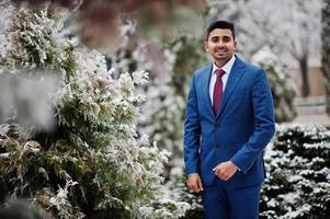 Elegant indian fashionable man model on suit posed at winter day. photo
