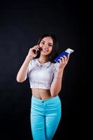 Portrait of a happy woman posing with passport and smartphone. photo