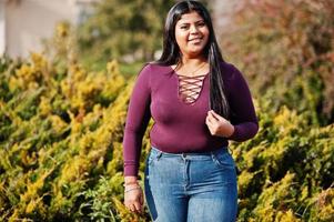 Pretty latino xxl model girl from Ecuador wear on violet blouse posed at street. photo