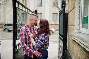 Stylish couple wear on checkered shirt in love together. photo