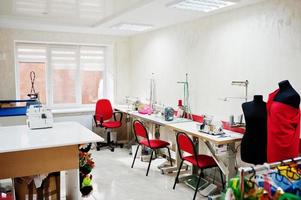 Workplace of seamstress office with sewing machine on table. photo