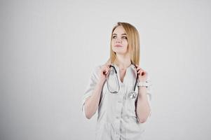 Blonde doctor nurse with stethoscope isolated on white background. photo