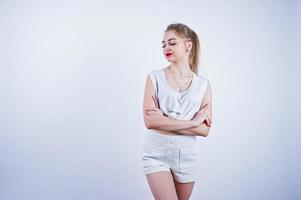 Amazing fit sexy body brunette caucasian girl posing at studio against white background on shorts and top. photo