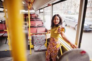 Young stylish african american woman riding on a bus. photo