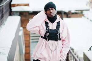 Stylish urban style african american man in pink hoodie posed at winter day. photo