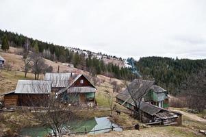 Old wooden vintage and rusty house at Carpathian mountains. photo