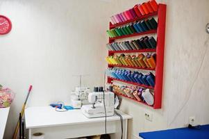 Workplace of seamstress office with sewing machine on table. photo