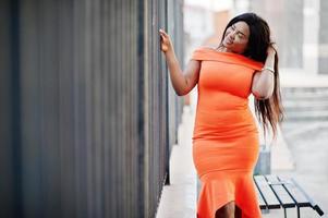 African american woman model xxl in orange dress. photo