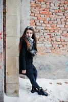 Brunette stylish casual girl in scarf against abandoned factory place. photo