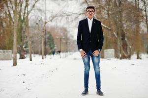 Stylish indian student man in suit and glasses posed at winter day outdoor. photo