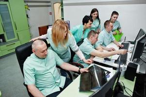 Medical theme.Observation room with a computer tomograph. The group of doctors meeting in the mri office at diagnostic center in hospital. photo