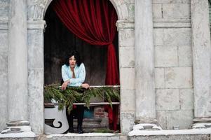 Stylish african american plus size model under ancient arch. photo