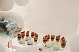 Candy bar decoration setup with delicious cakes and sweets. photo