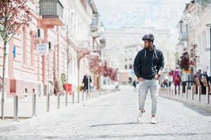 Portrait of young stylish indian man model pose in street. photo