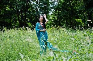 Portrait of beautiful indian brumette girl or hindu woman model. Traditional Indian costume lehenga choli. photo