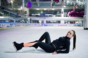 Figure skater woman at ice skating rink. photo