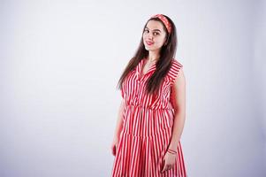 Portrait of a gorgeous young girl in red striped dress in the studio. photo