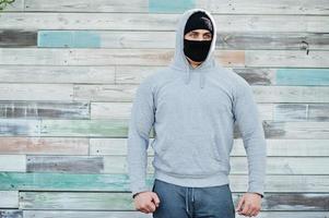 Portrait sports arabian man in black medical face mask and hoodie during coronavirus quarantine. photo