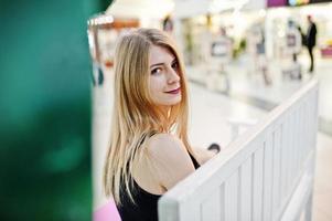 Girl with shopping bags in the mall sitting on bench. photo