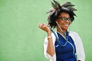 Portrait of African American female doctor with stethoscope wearing lab coat. photo