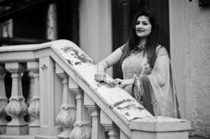 Indian hindu girl at traditional violet saree posed at  street. photo