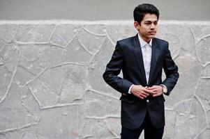 Young indian man on suit posed outdoor. photo