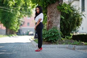 Stylish african american business woman on streets of city. photo