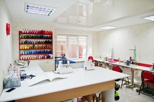 Workplace of seamstress office with sewing machine on table. photo