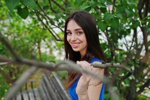 Teenage girl in blue dress posed outdoor at sunny day. photo