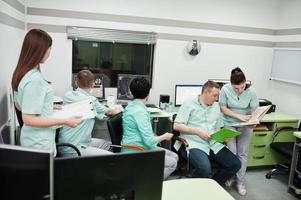 Medical theme.Observation room with a computer tomograph. The group of doctors meeting in the mri office at diagnostic center in hospital. photo