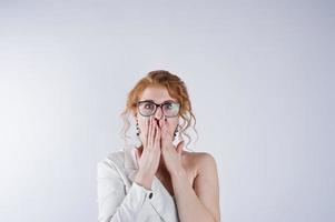 Curly hair girl astonished face in glasses isolated on white studio background. photo