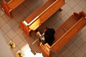 African american woman praying in the church. Believers meditates in the cathedral and spiritual time of prayer. View from above. photo