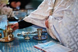 Hand of priest at rite of baptism. photo