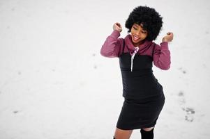 Curly hair african american woman posed at winter day. Afro model girl against snow. photo