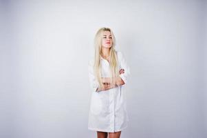 Attractive blonde female doctor or nurse  in lab coat isolated on white background. photo