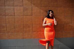 African american woman model xxl in orange dress. photo