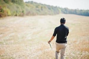 South asian agronomist farmer inspecting wheat field farm. Agriculture production concept. photo