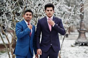 Two elegant indian fashionable mans model on suit posed at winter day. photo