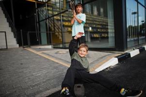 Two brothers with skateboard at stadium. photo