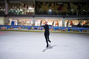 Figure skater woman at ice skating rink. photo